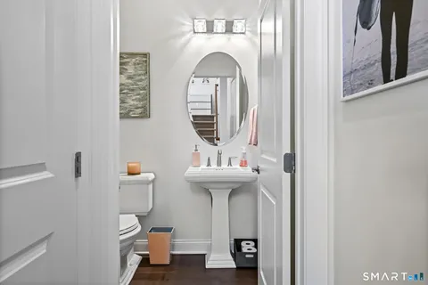 a bathroom with a sink a mirror and toilet