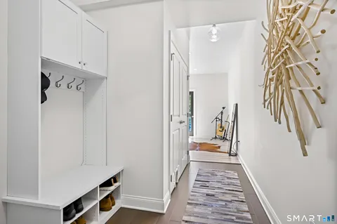 a view of a hallway with closet and wooden floor