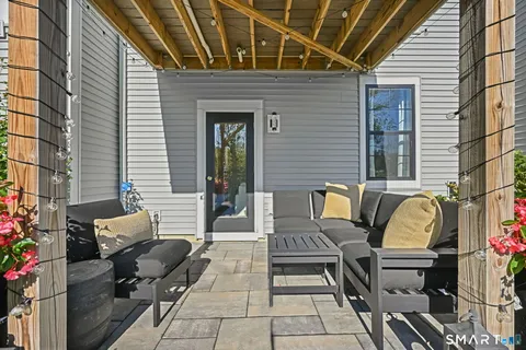 a view of a patio with couple of chairs and a couch