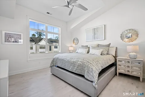 a bedroom with a large bed and a window