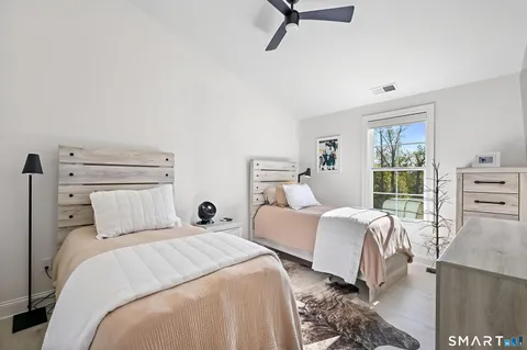 a bedroom with a bed a couch and a window