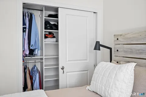 a bedroom with a bed and a closet