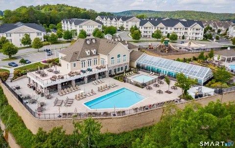 an aerial view of residential house with outdoor space and swimming pool
