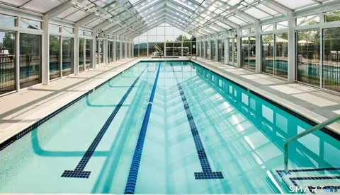 a view of swimming pool with a large window and swimming pool