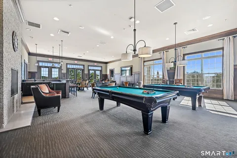 a living room with furniture a table and a potted plant