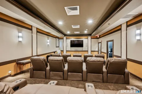 a media room with lots of chairs and a projector screen