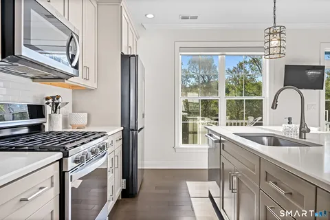 a kitchen that has a sink and a stove