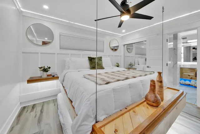 a bedroom with a bed and ceiling fan