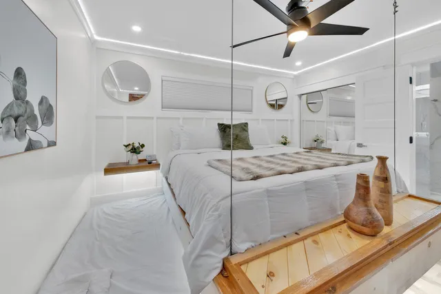 a bedroom with a bed and ceiling fan