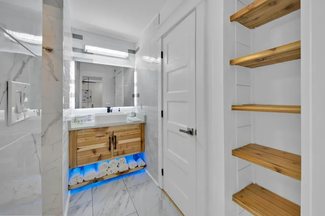 a bathroom with a sink mirror and a bathtub