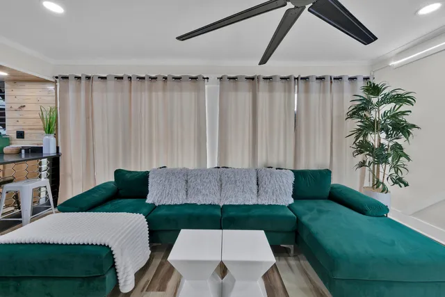 a living room with furniture and a potted plant