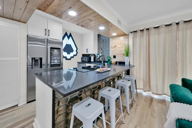 a room with lots of furniture and wooden floors