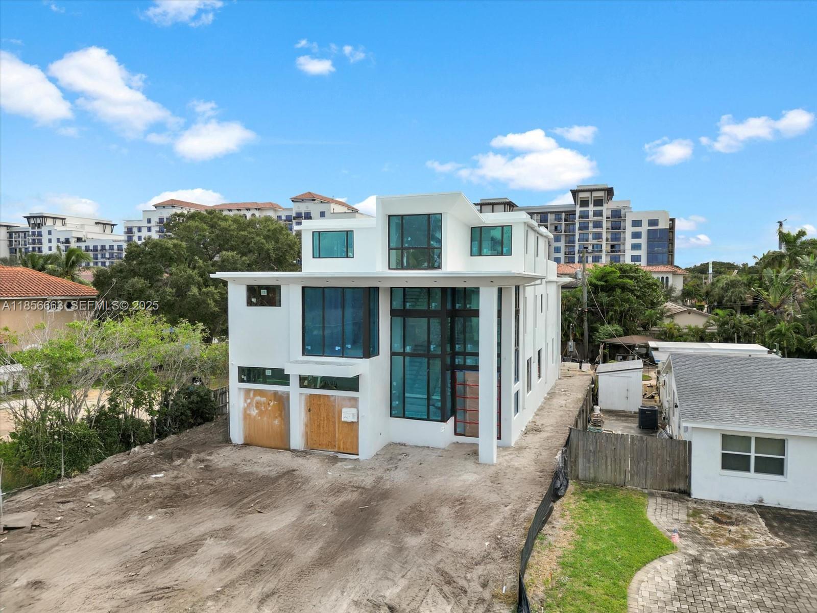 310 Northeast 2nd Street Boca Raton, FL 33432 - Photo 2 of 10 a front view of a house with a yard