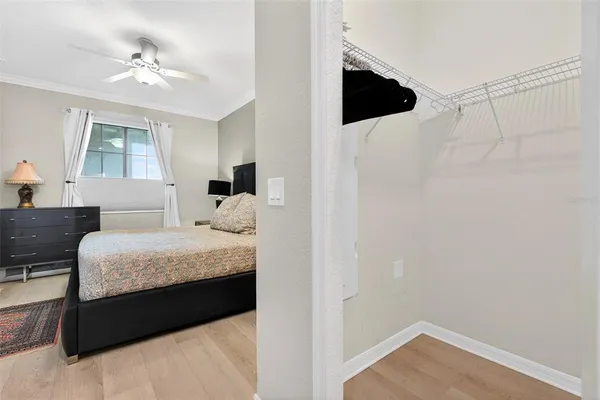 a kitchen with stainless steel appliances kitchen island granite countertop a stove a sink a microwave a dining table and chairs with wooden floor