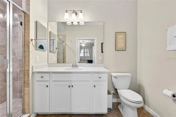 a kitchen with stainless steel appliances a table chairs refrigerator and microwave