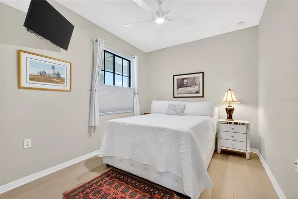 a kitchen with stainless steel appliances granite countertop a kitchen island a stove a sink a refrigerator and white cabinets