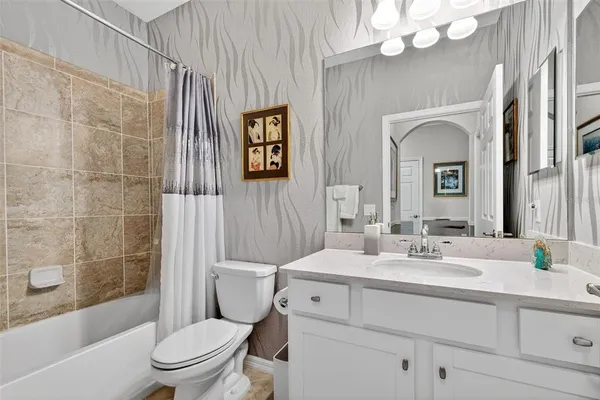 a large kitchen with kitchen island granite countertop a large counter top cabinets and stainless steel appliances