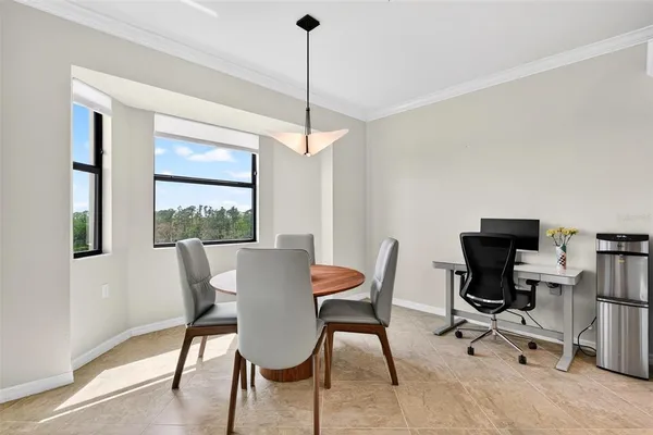 a living room with furniture and a view of kitchen