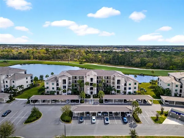 a view of a house with a big yard and large trees