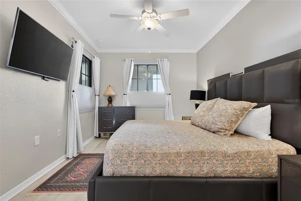 a bedroom with a bed and a painting on the wall