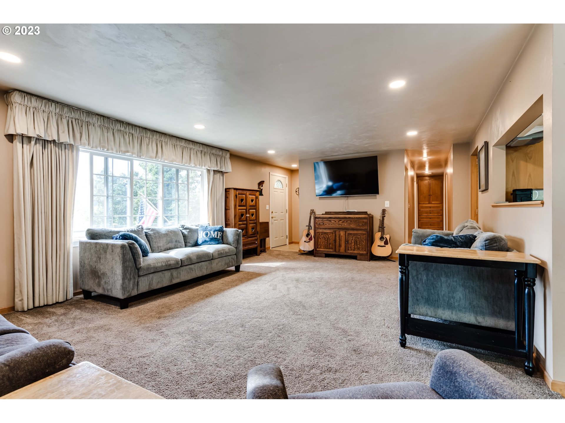 82277 Rattlesnake Road Dexter, OR 97431 - Photo 16 of 42 a living room with furniture a fireplace and a flat screen tv