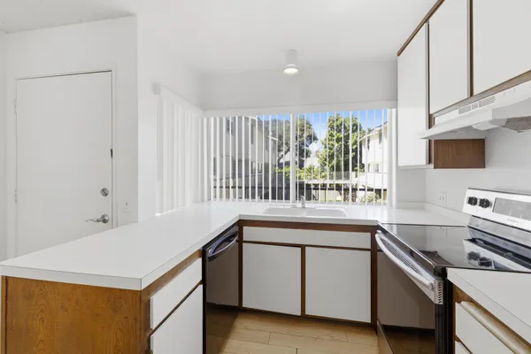 a kitchen that has a sink and a stove in it