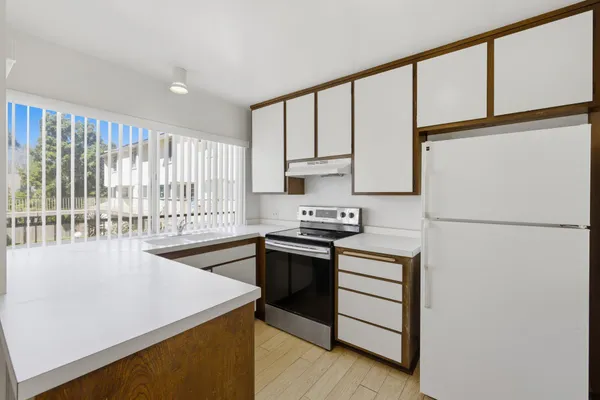 a kitchen with a stove a sink and a refrigerator
