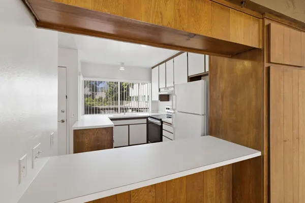 a kitchen with stainless steel appliances a refrigerator and a stove