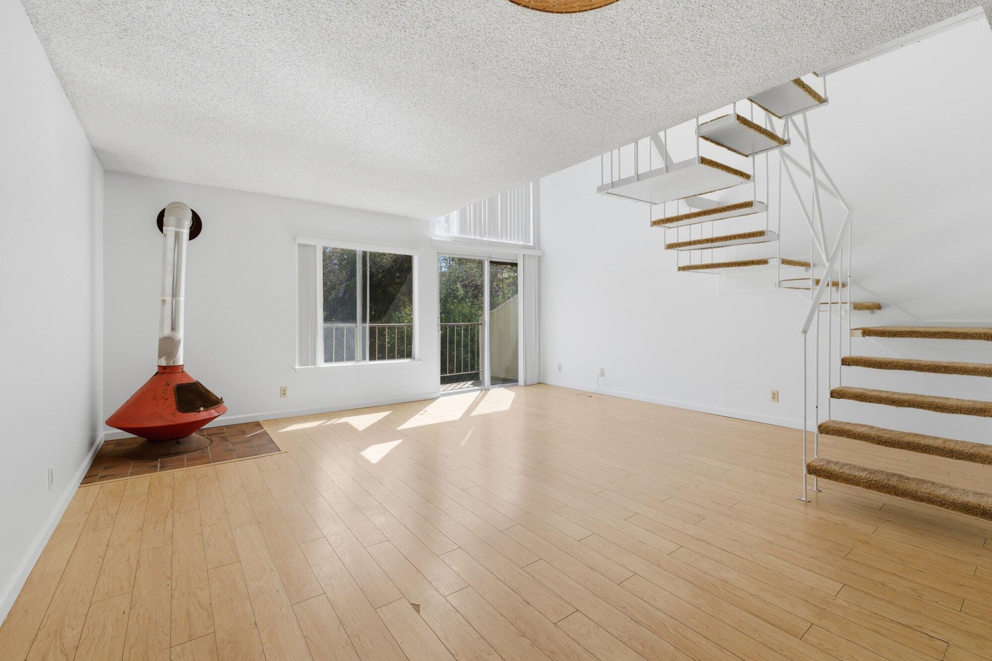 5455 8th Street, Unit 58 Carpinteria, CA 93013 - Photo 18 of 38 an empty room with wooden floor and windows
