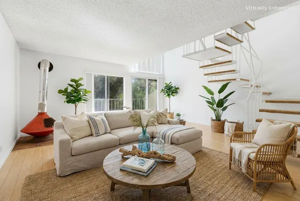 a living room with furniture and a potted plant