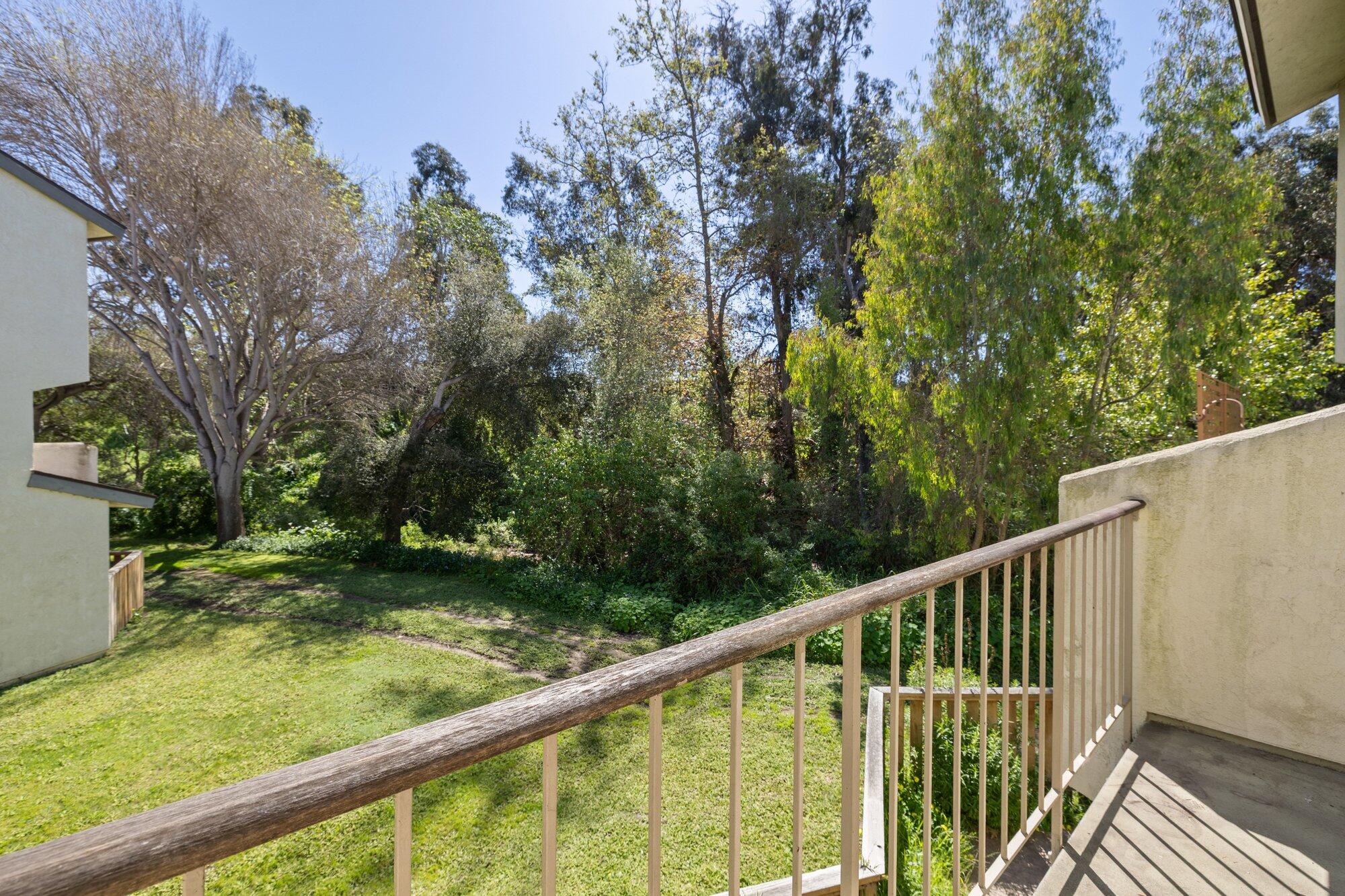 5455 8th Street, Unit 58 Carpinteria, CA 93013 - Photo 28 of 38 a view of a wooden deck and a yard with swimming pool