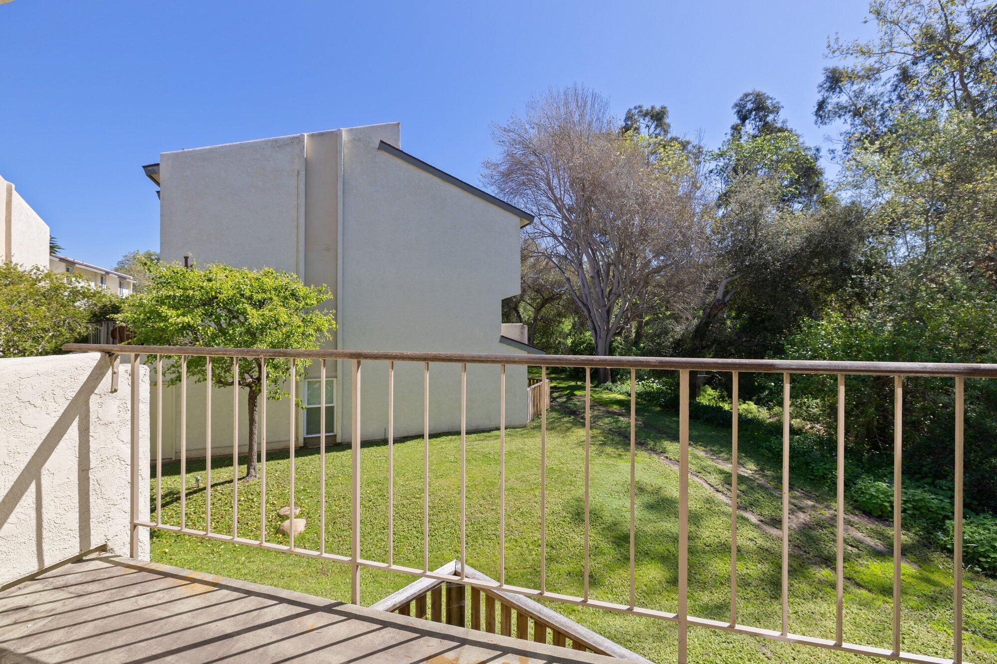 5455 8th Street, Unit 58 Carpinteria, CA 93013 - Photo 29 of 38 a view of a balcony with floor to ceiling window and wooden fence
