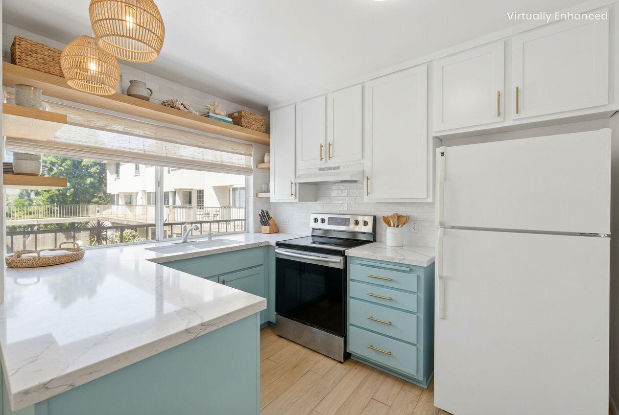 5455 8th Street, Unit 58 Carpinteria, CA 93013 - Photo 4 of 38 a kitchen with a stove a refrigerator and a sink