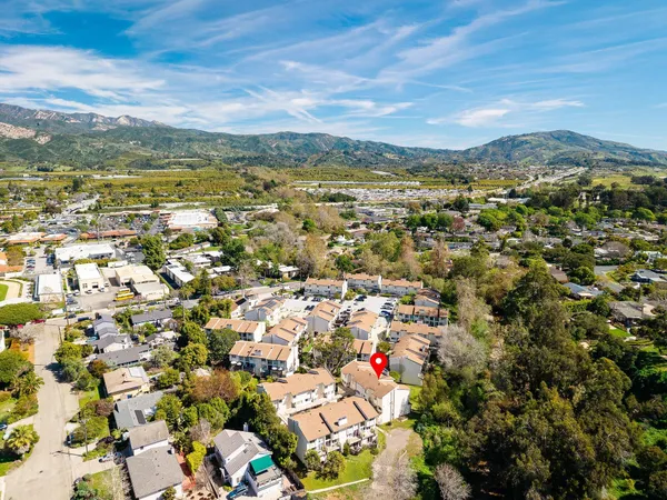 an aerial view of residential houses with city view