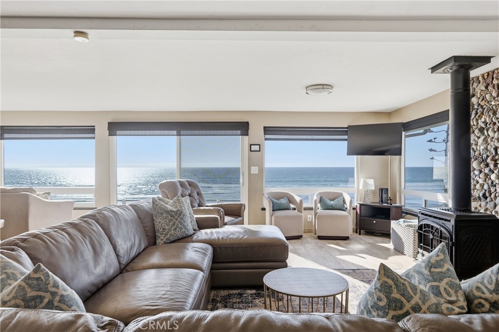 2712 Studio Drive Cayucos, CA 93430 - Photo 7 of 25 The open-concept living room, dining room, and kitchen are framed by expansive modern dual pane windows that fill the home with natural light and capture panoramic views of the Pacific.