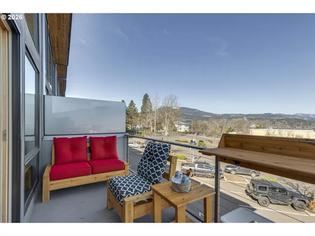 a view of a balcony with furniture and city view