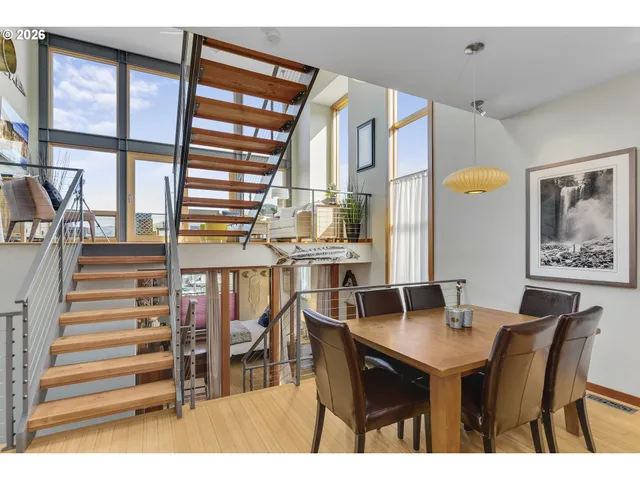 a dining room with furniture and wooden floor