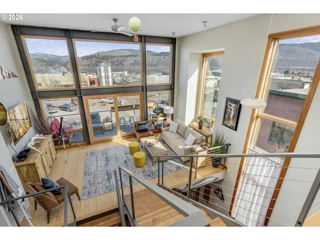 a living room with furniture and a floor to ceiling window