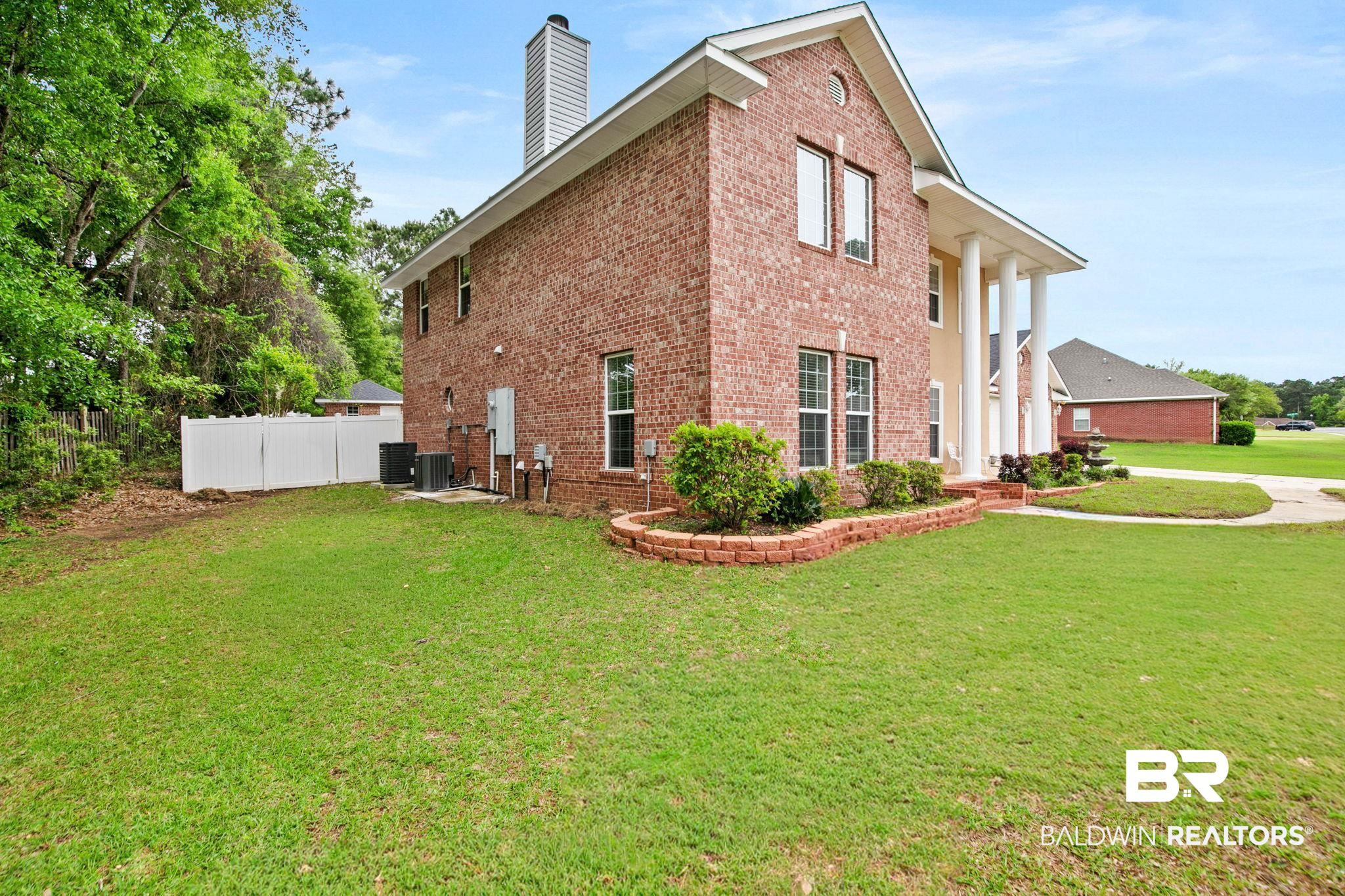 2 Speckle Trout Route Daphne, AL 36527 - Photo 8 of 61 View of home's exterior featuring brick siding and a chimney