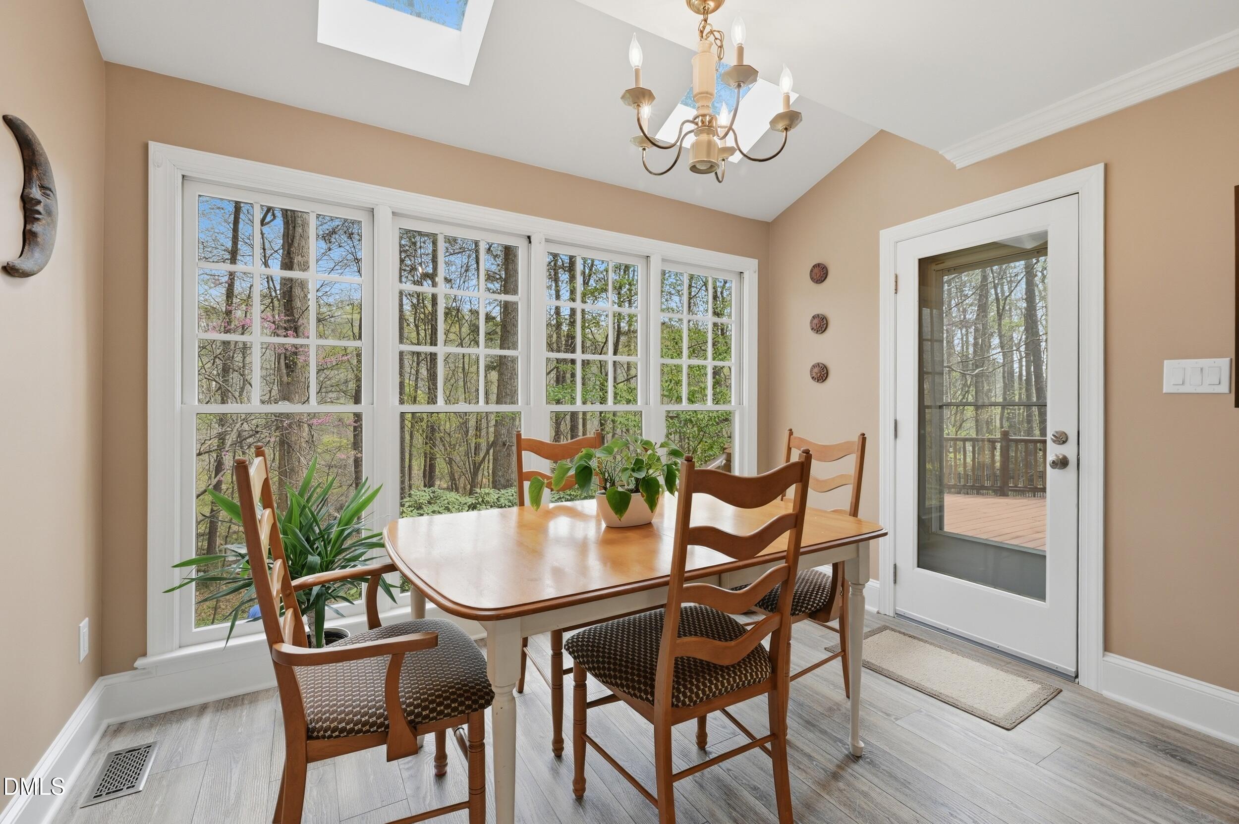 4001 Stemmons Court Raleigh, NC 27613 - Photo 12 of 45 a dining room with furniture a chandelier and wooden floor