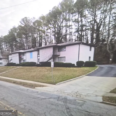 a view of a house with a yard and garage
