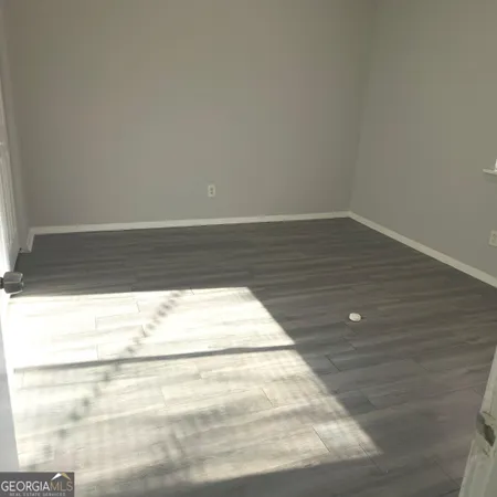 a bedroom with a bed and potted plant