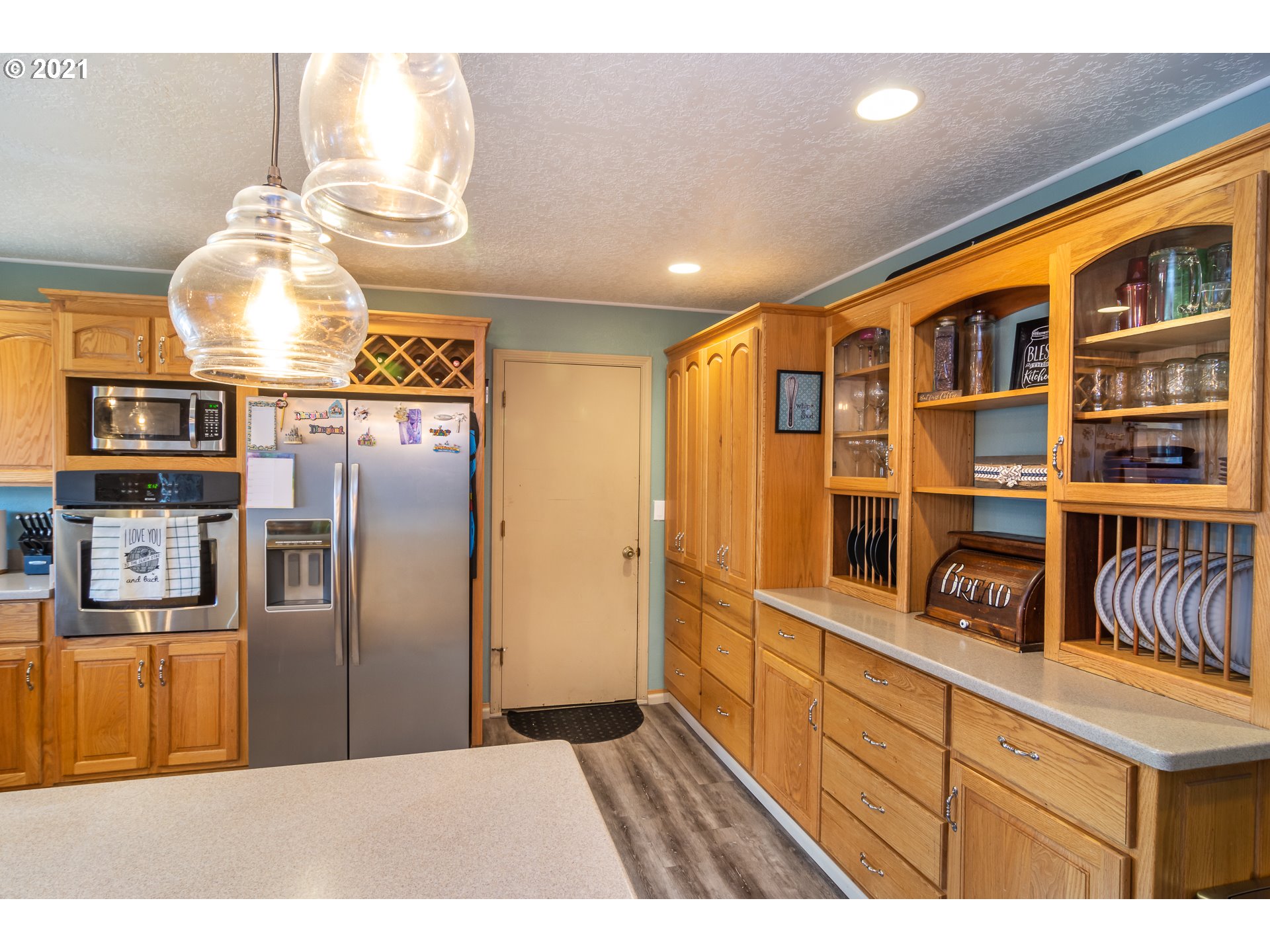 4105 Carnes Road Roseburg, OR 97471 - Photo 8 of 32 a kitchen with stainless steel appliances granite countertop a refrigerator and a wooden cabinets