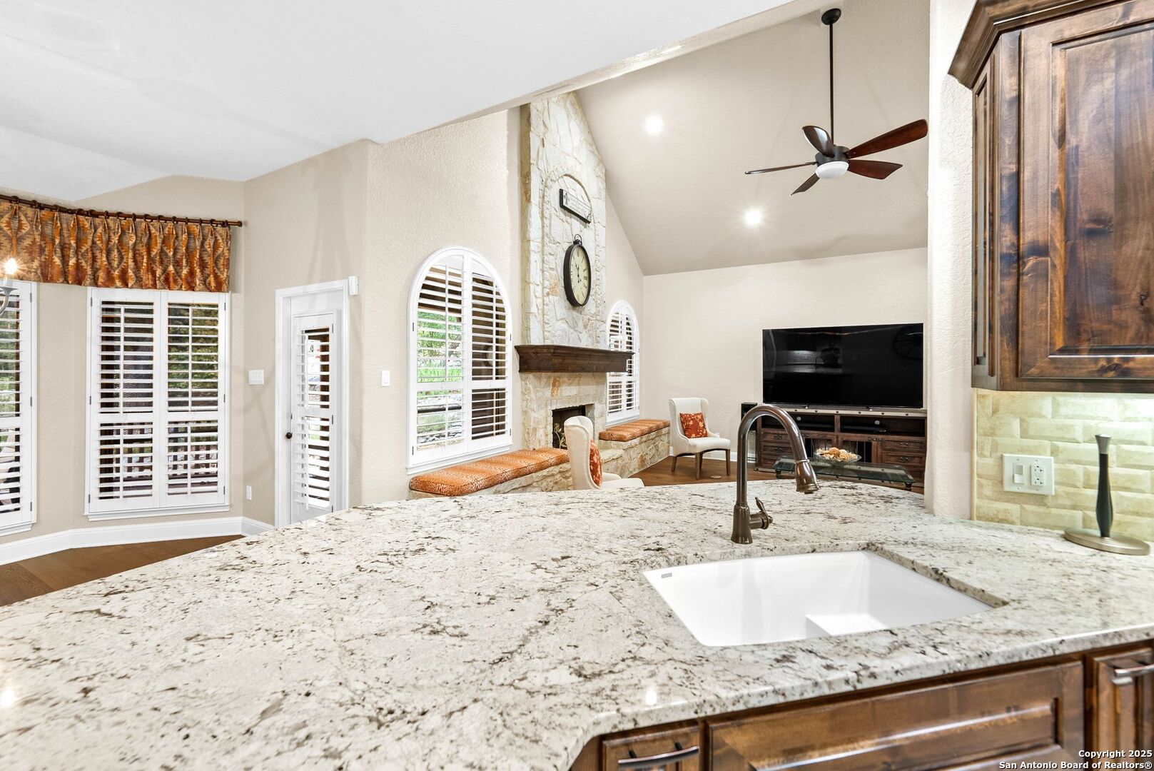 15921 Reyes Ridge Helotes, TX 78023 - Photo 13 of 68 a kitchen with granite countertop a sink and a window