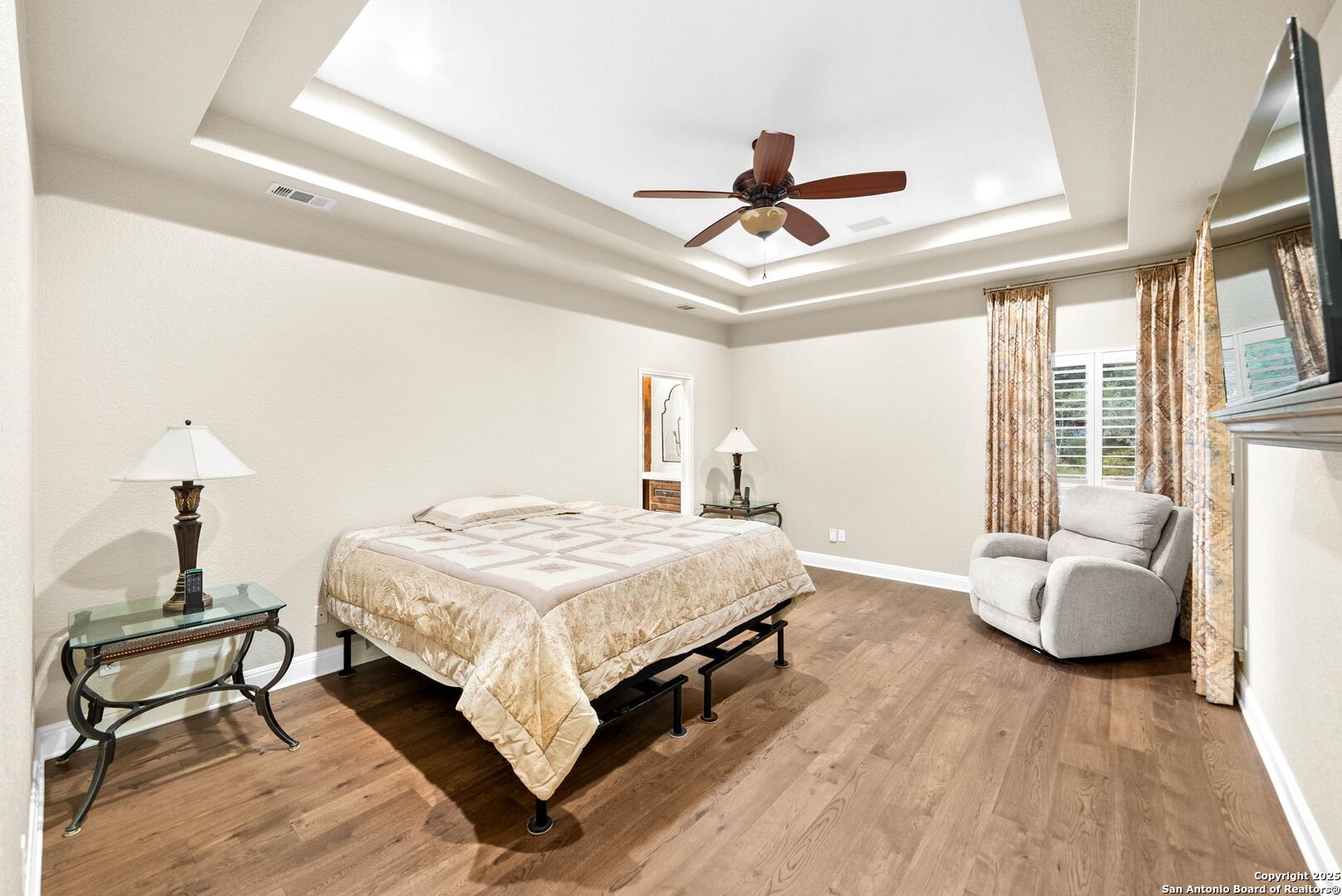 15921 Reyes Ridge Helotes, TX 78023 - Photo 16 of 68 a bedroom with a bed and wooden floor