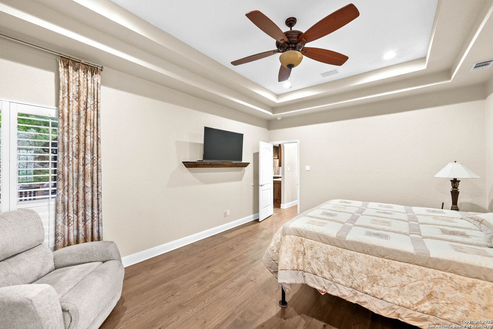 15921 Reyes Ridge Helotes, TX 78023 - Photo 18 of 68 a bedroom with a bed window and a flat screen tv