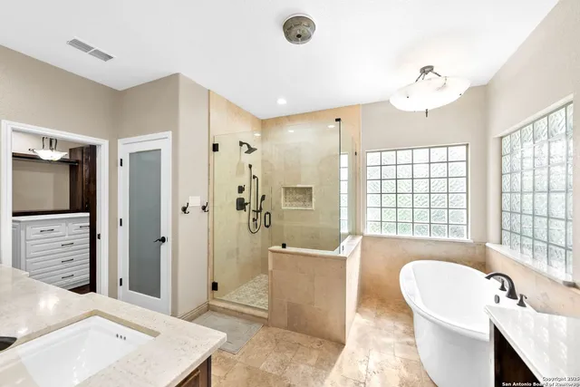 a view of a hallway with closet and chandelier