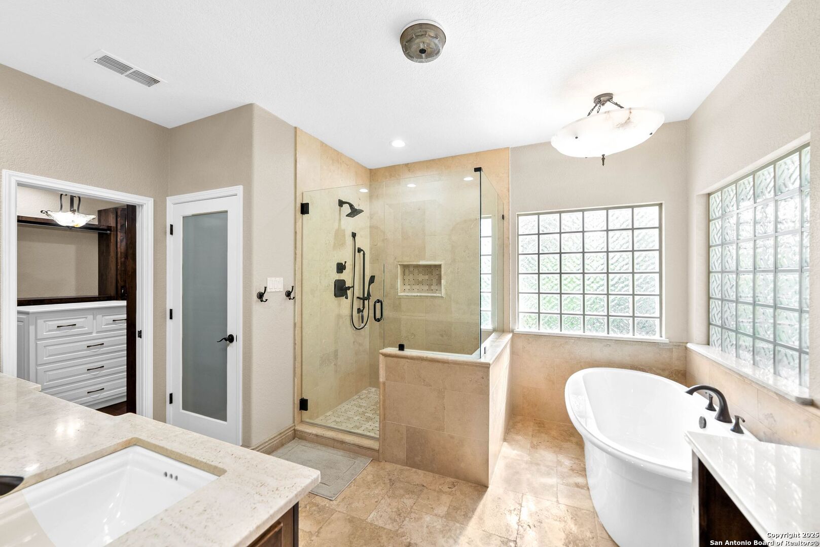 15921 Reyes Ridge Helotes, TX 78023 - Photo 19 of 68 a spacious bathroom with a tub shower and sink