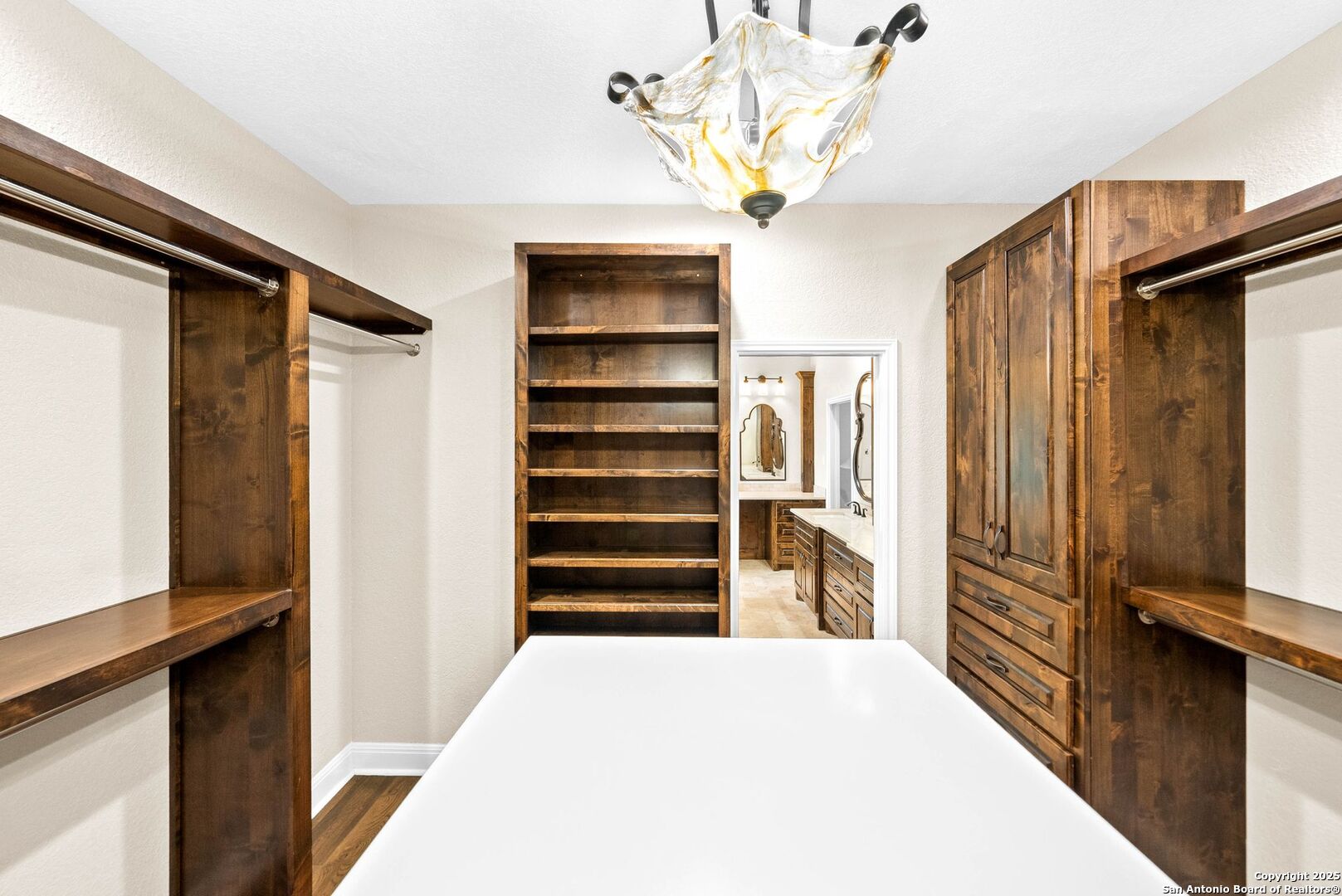 15921 Reyes Ridge Helotes, TX 78023 - Photo 24 of 68 a view of a hallway with closet and chandelier