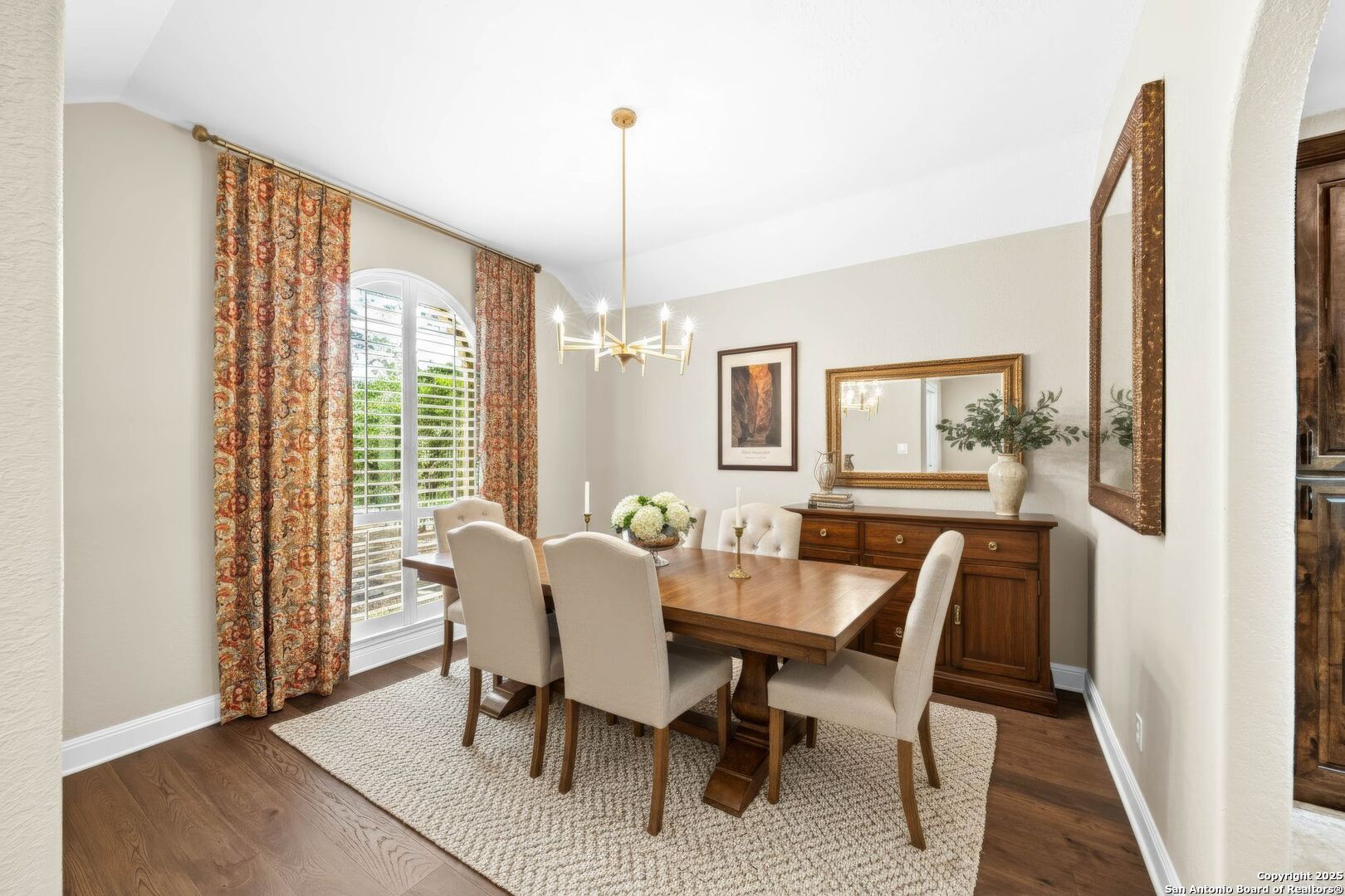 15921 Reyes Ridge Helotes, TX 78023 - Photo 30 of 68 a view of a dining room with furniture a chandelier and wooden floor